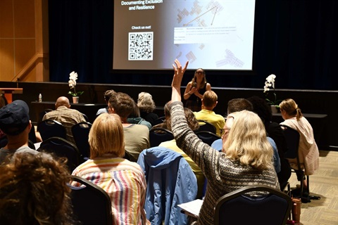 Picture of Audience Member raising hand at LAM Panel