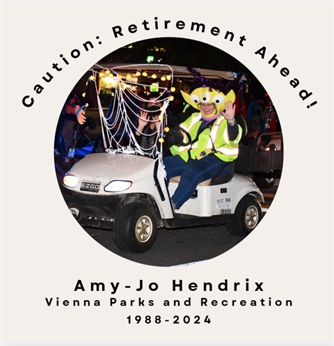 Vienna staff member driving a golf cart wearing an Alien Costume. 